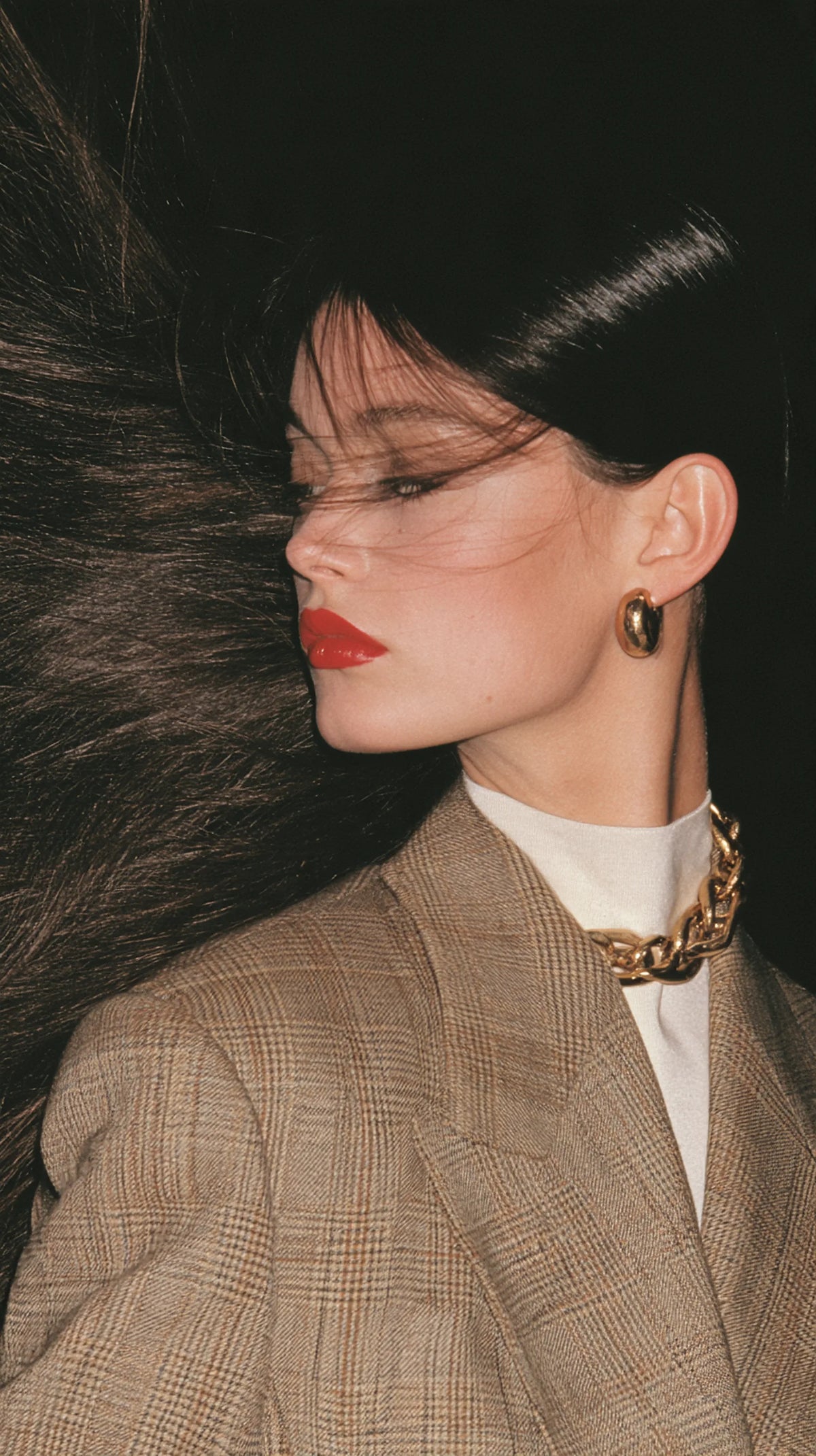 Editorial portrait, hair caught mid-motion in an arc